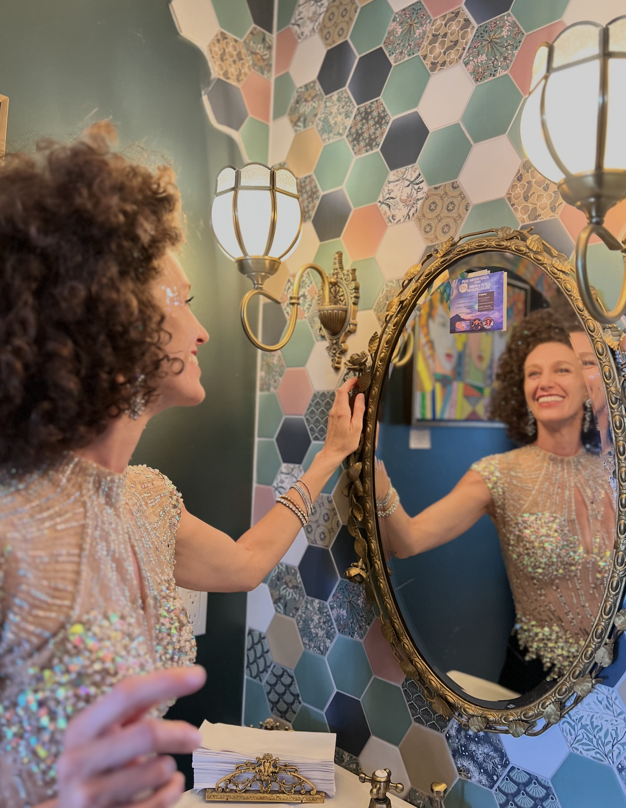 Bride admiring reflection in ornate mirror at Sunset Parlor getting-ready suite