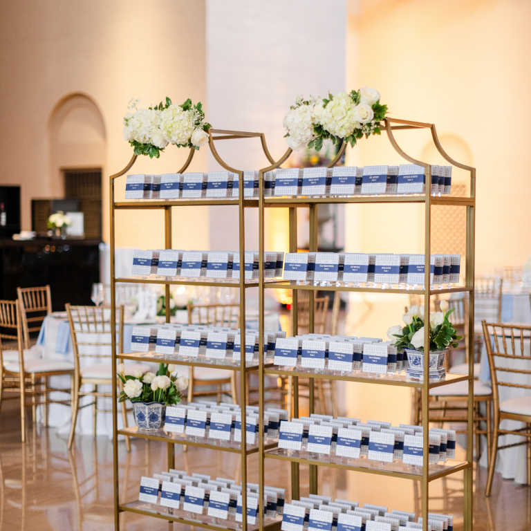 Tiered dessert display with macarons and treats on ornate shelving at wedding reception