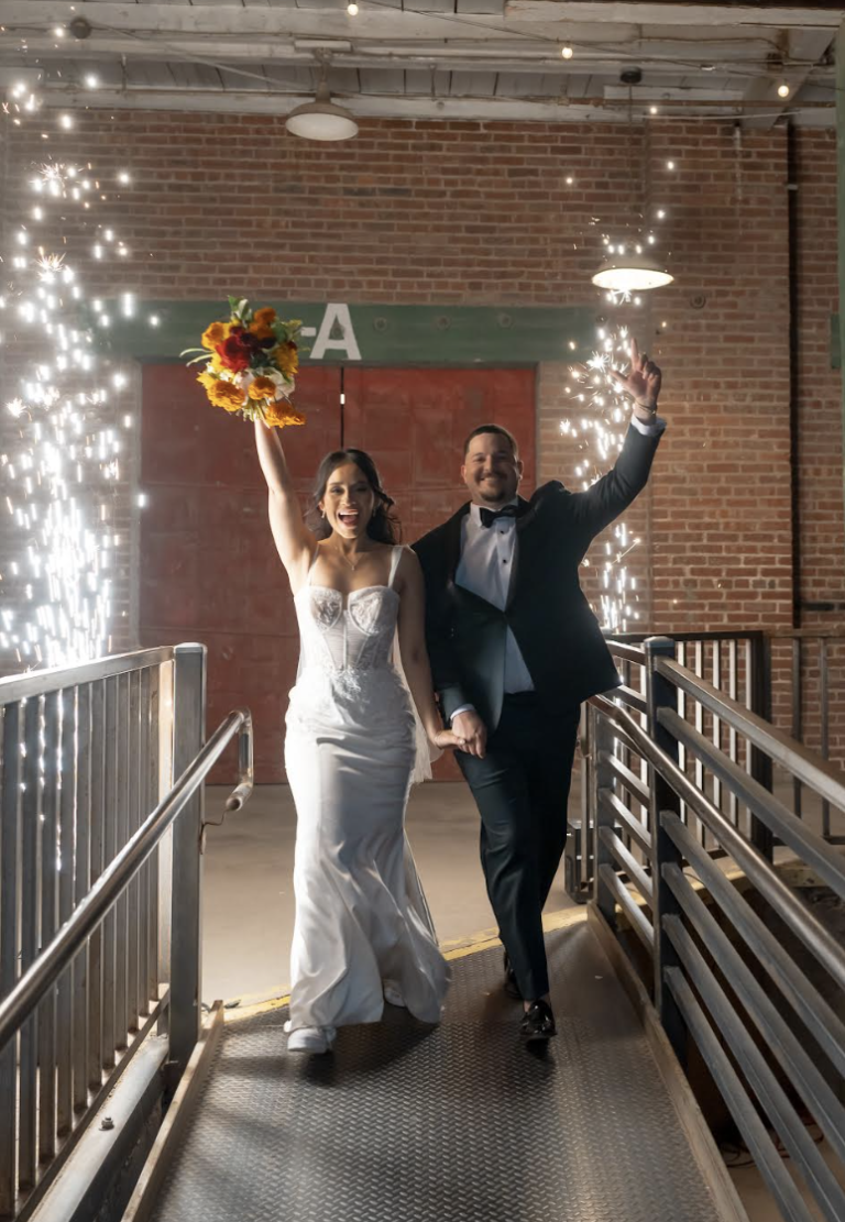 Newlyweds celebrate their grand exit with sparklers in industrial brick venue
