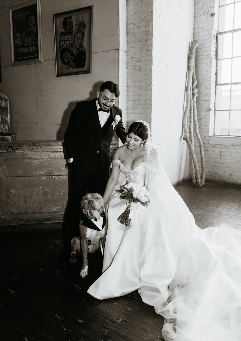 Black and white photo of bride and groom seated together in vintage industrial space