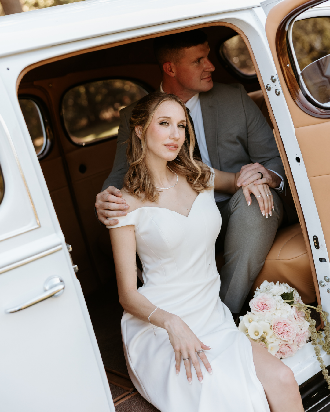 bride and groom in a getaway car