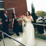 Bride holding a bouqet and a drink