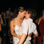 bride and groom dancing and smiling on wedding day