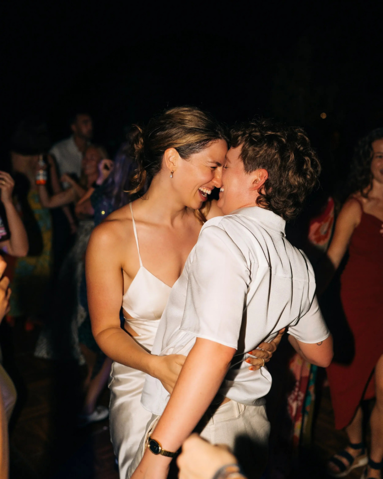 bride and groom dancing and smiling on wedding day