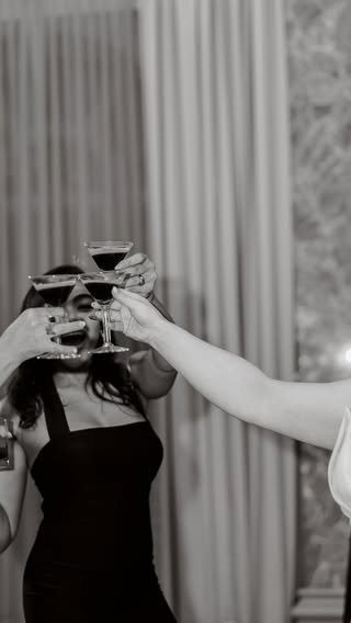 Bridesmaids toasting with cocktail glasses in black and white photo