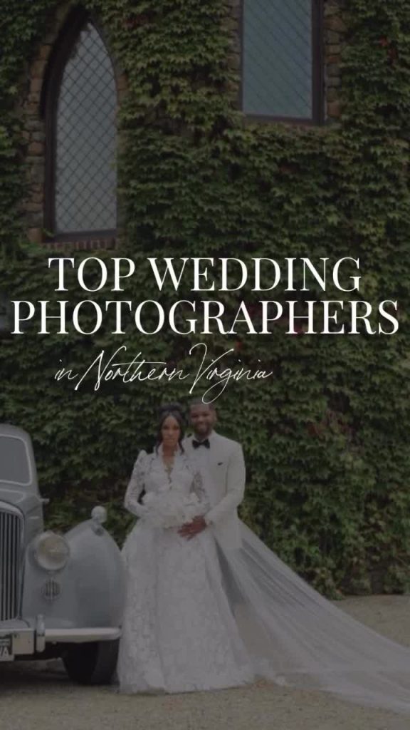 Bride and groom standing beside vintage white car in front of ivy-covered stone building