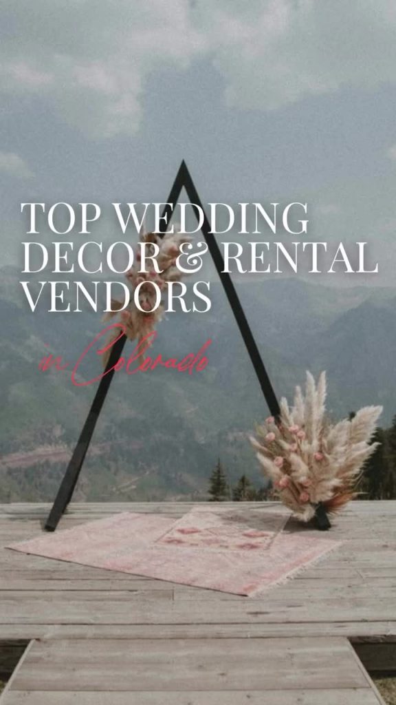 Modern black triangle wedding arch with pampas grass and pink florals overlooking Colorado mountains