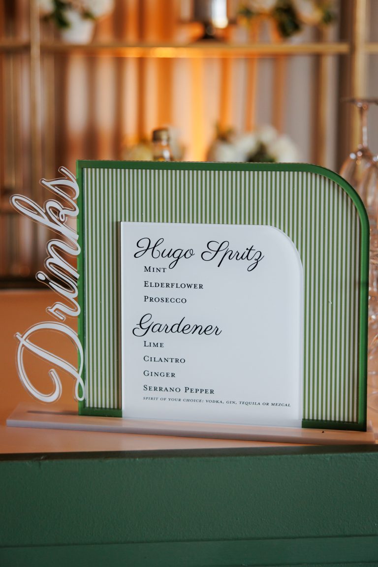 Green striped frame displaying custom wedding invitation with Maggie & Pauly's names and event details