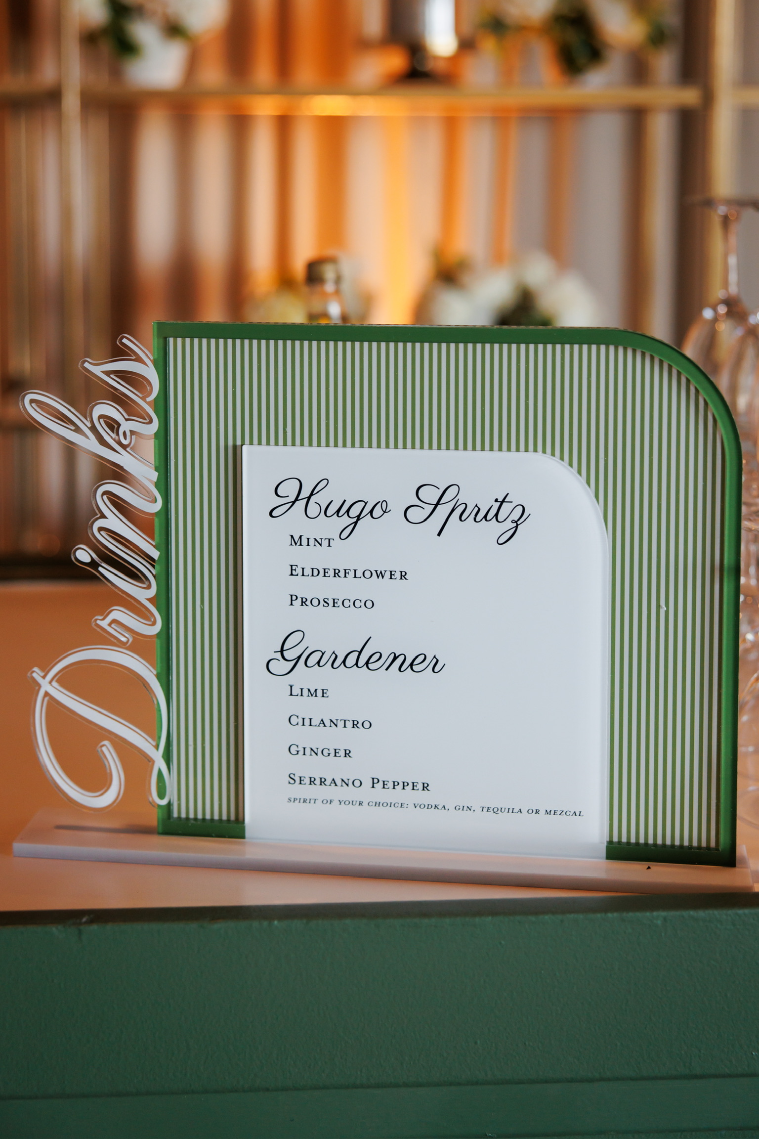 Green striped frame displaying custom wedding invitation with Maggie & Pauly's names and event details