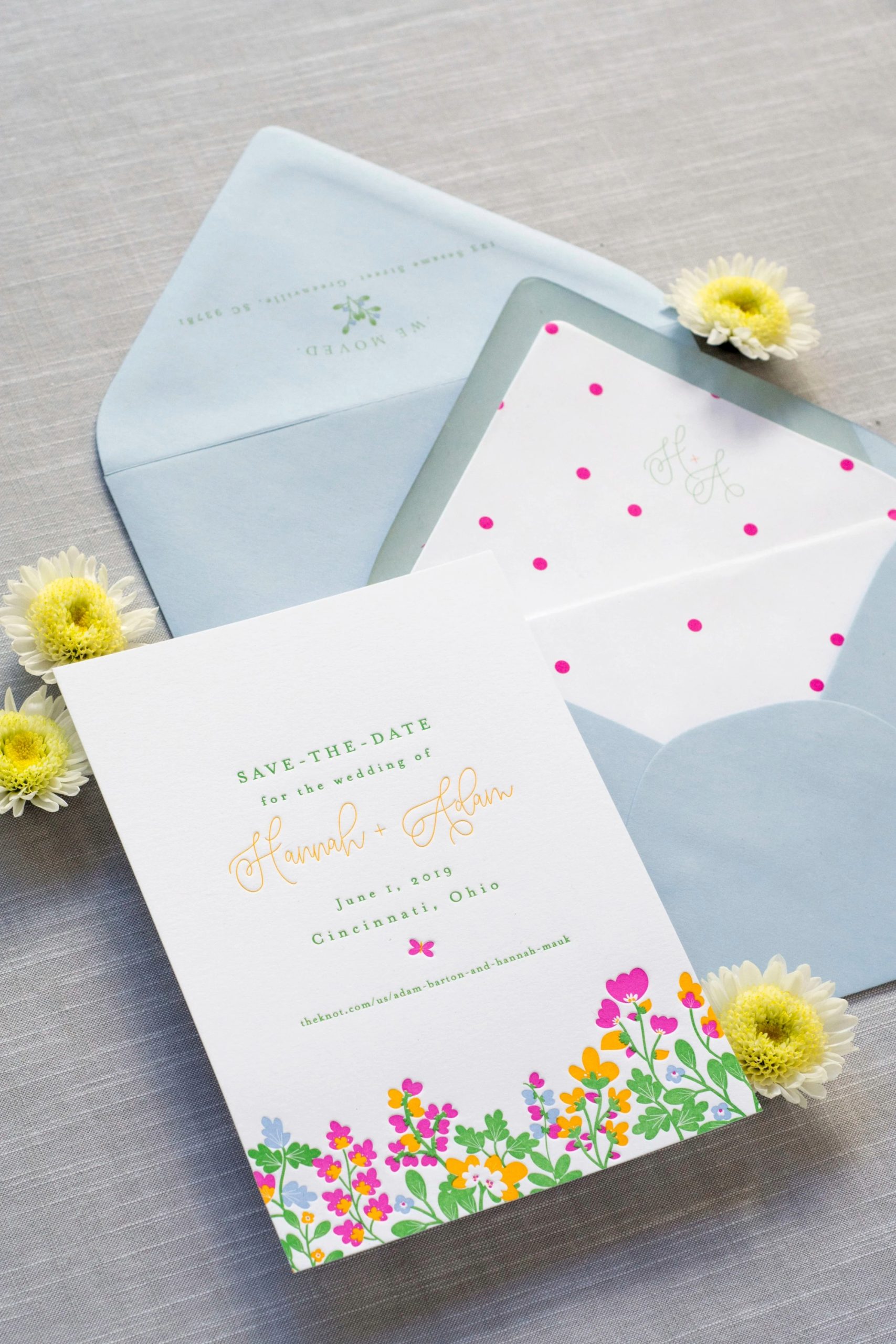 Wedding save-the-date card with colorful floral border and polka dot envelope liner, accented with yellow chrysanthemums
