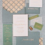 Wedding invitation suite in sage green and blush pink with rose gold calligraphy, including envelope liner with geometric tile pattern, menu cards, and wax seals