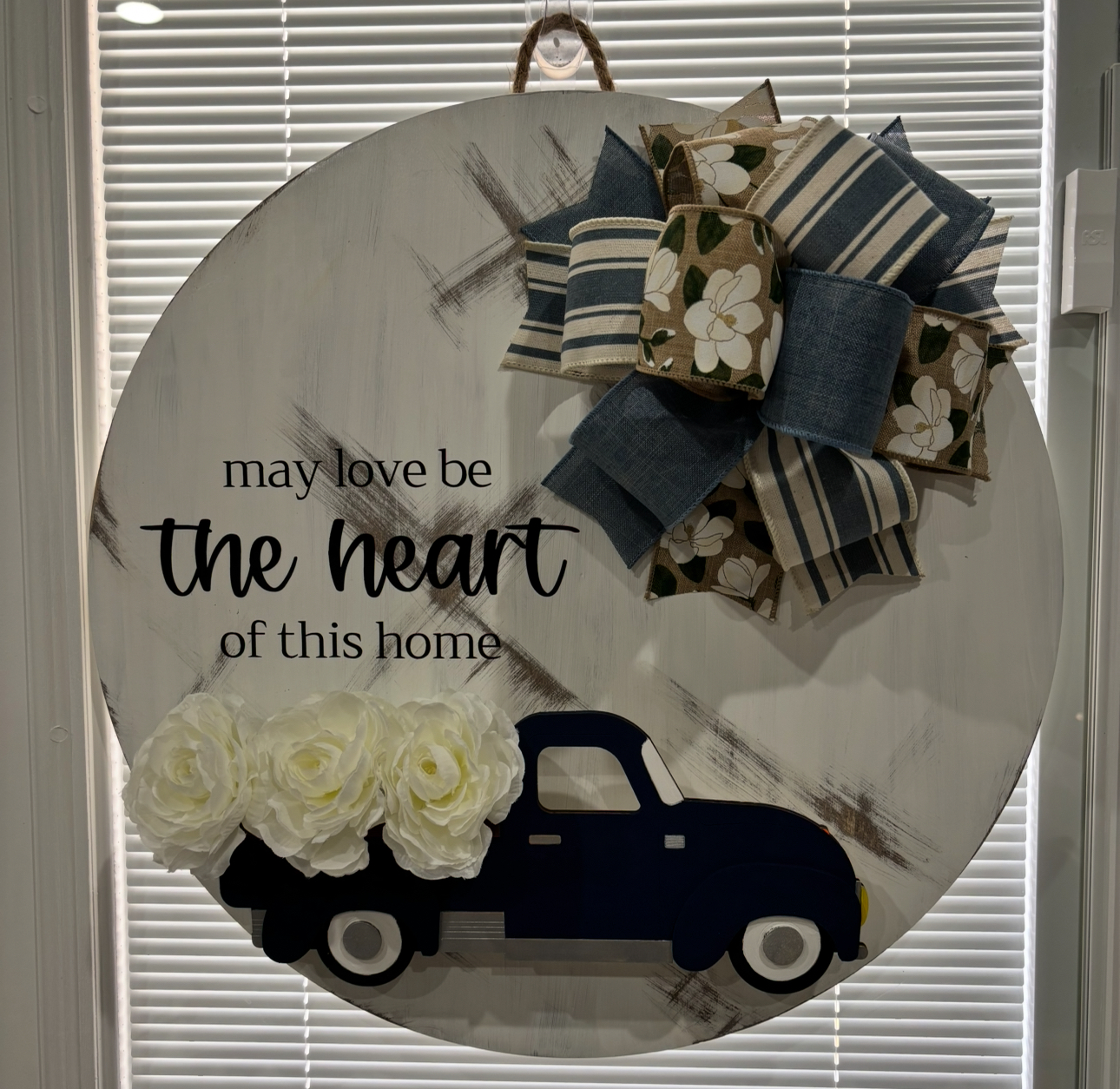 Round door hanger with truck design and text "Love has no speed limit to the heart of this family"