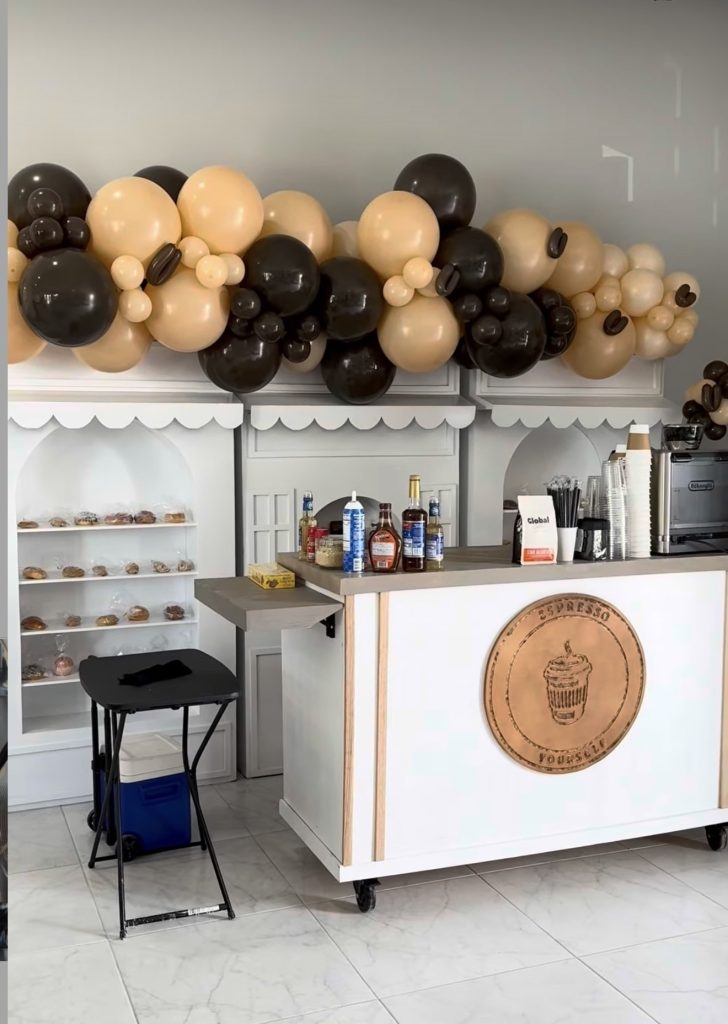 Espresso Yourself mobile coffee bar with balloon garland, dessert display, and branded service counter