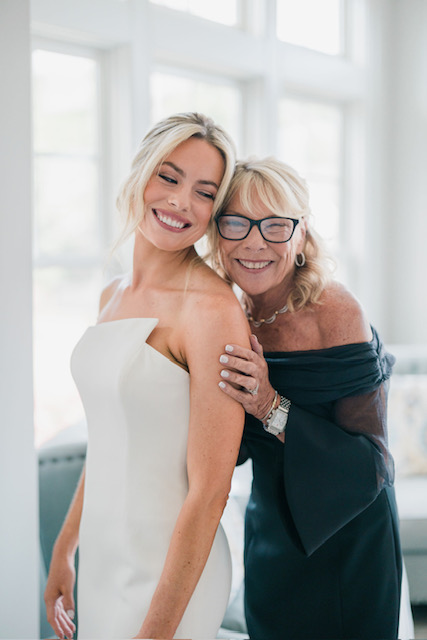 Happy bride and mother share a tender moment before the ceremony