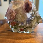 Hexagonal clear resin keepsake with preserved blush roses, white ranunculus, and baby's breath from wedding bouquet