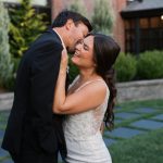 Newlywed couple embracing in garden setting after wedding ceremony