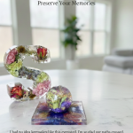 S-shaped resin letter and sphere paperweight filled with preserved wedding flowers including roses and purple blooms