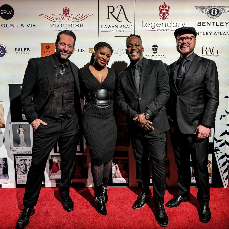 AMP'D Entertainment wedding DJ team of four posed on red carpet in formal attire