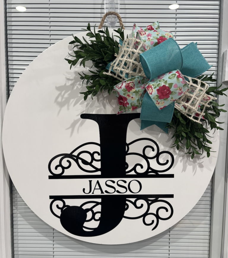 Personalized round door hanger with split monogram letter J and "JASSO" surname, decorated with turquoise and floral ribbon bow