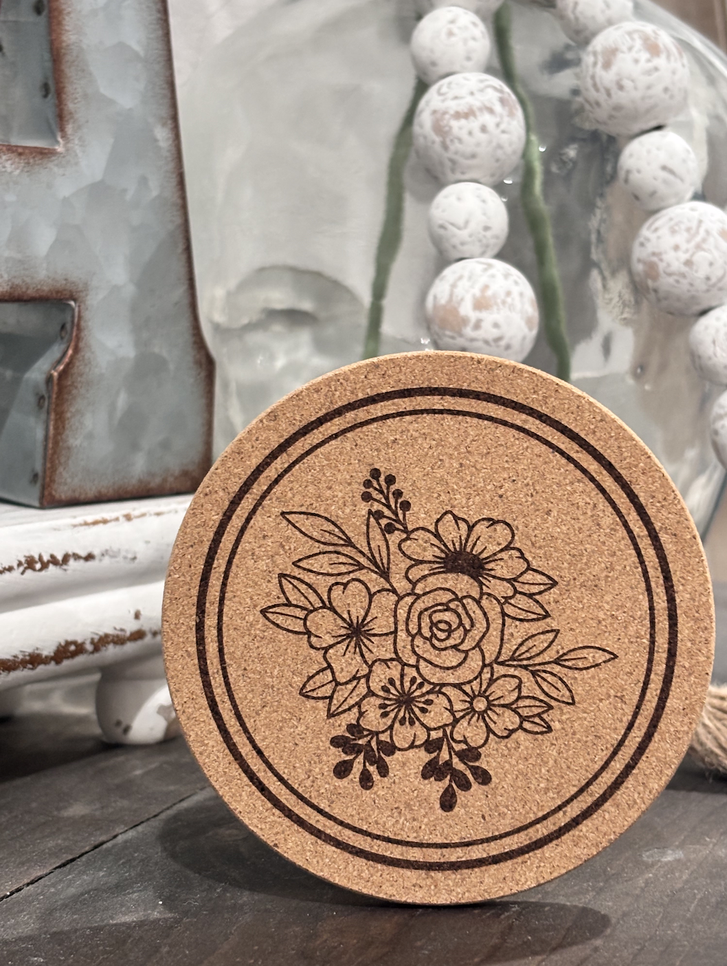 Cork coaster featuring engraved floral bouquet design with roses and daisies for wedding events