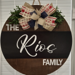 Personalized round door sign reading "The Rios Family" with patriotic red, white, and blue burlap bow