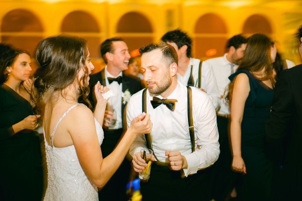 Victoria and Anthony dancing together surrounded by guests at their wedding reception