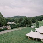 Wedding venue estate with twin peaked tents, stone cottages, and tree-lined driveway in Northern Virginia countryside