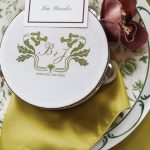 Wedding place setting with custom monogrammed coaster and burgundy orchid