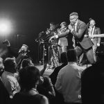 Live band performing on stage with dancing crowd at wedding reception