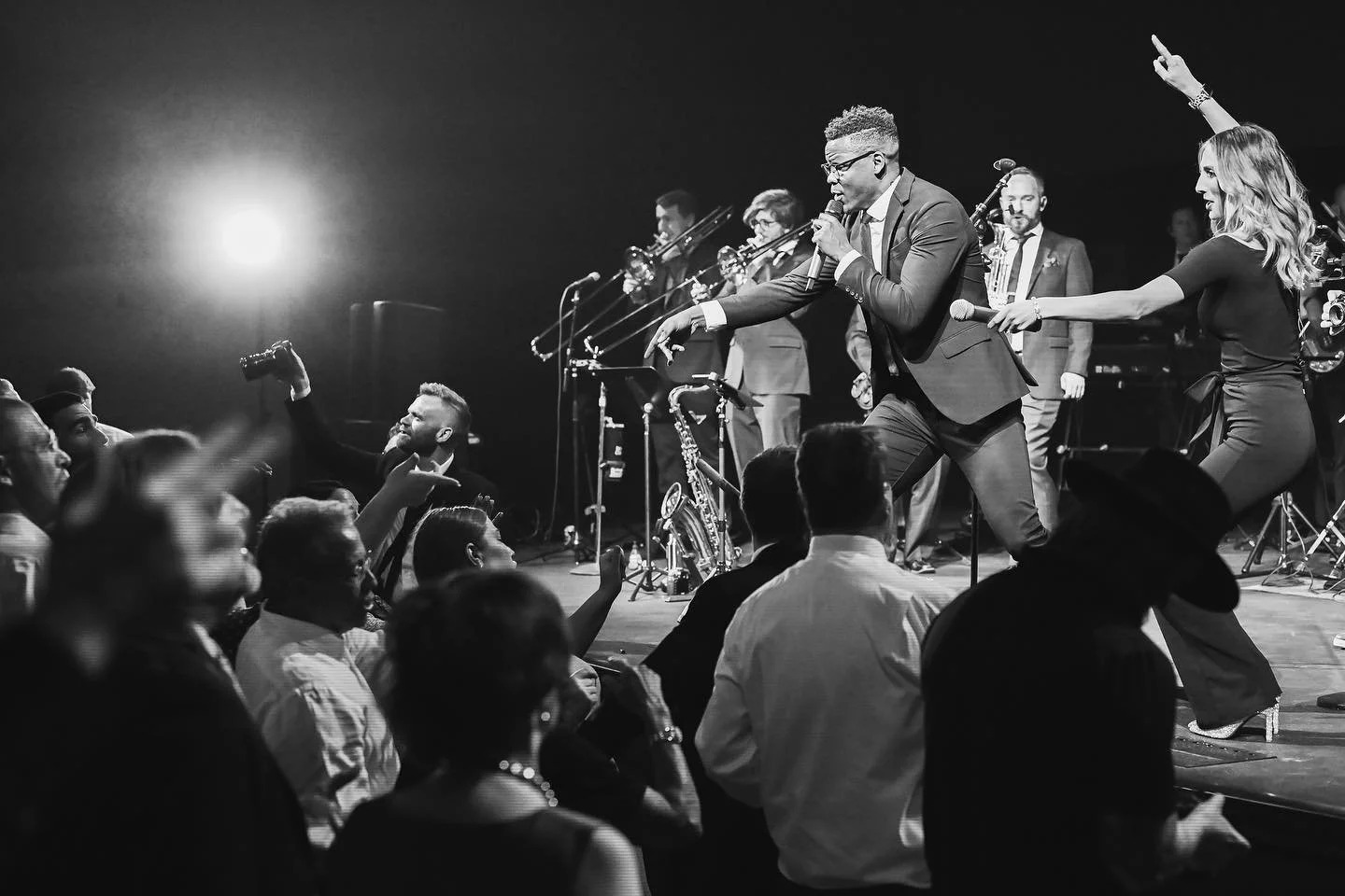 Live band performing on stage with dancing crowd at wedding reception