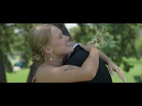 Bride joyfully embracing groom outdoors in natural garden setting