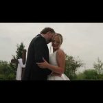 Bride and groom embracing outdoors in Nebraska with trees in background