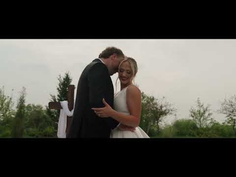 Bride and groom embracing outdoors in Nebraska with trees in background
