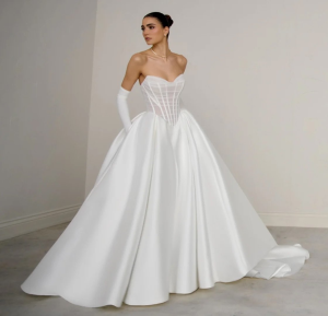 Bride in strapless white ball gown with corset bodice and voluminous skirt with train