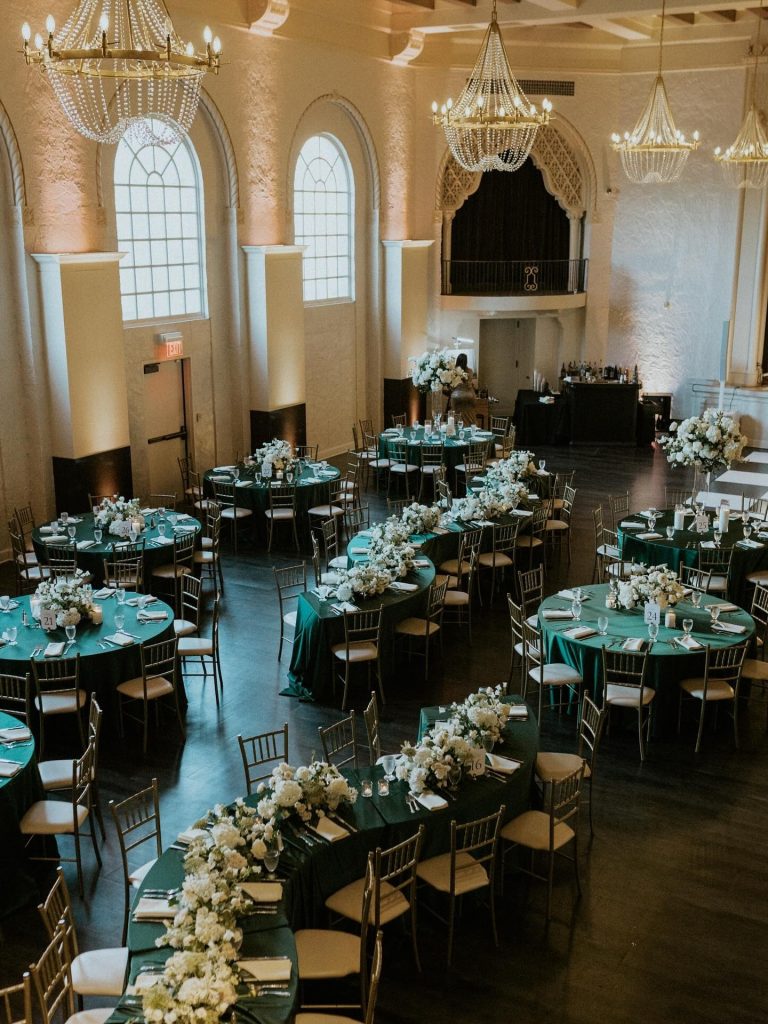 Classic Nebraska wedding reception venue with cathedral ceilings, statement lighting, and turquoise color scheme