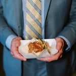 Businessman in suit holding golden Bitcoin cryptocurrency coin