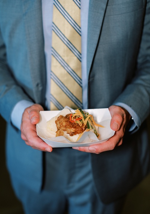 Businessman in suit holding golden Bitcoin cryptocurrency coin