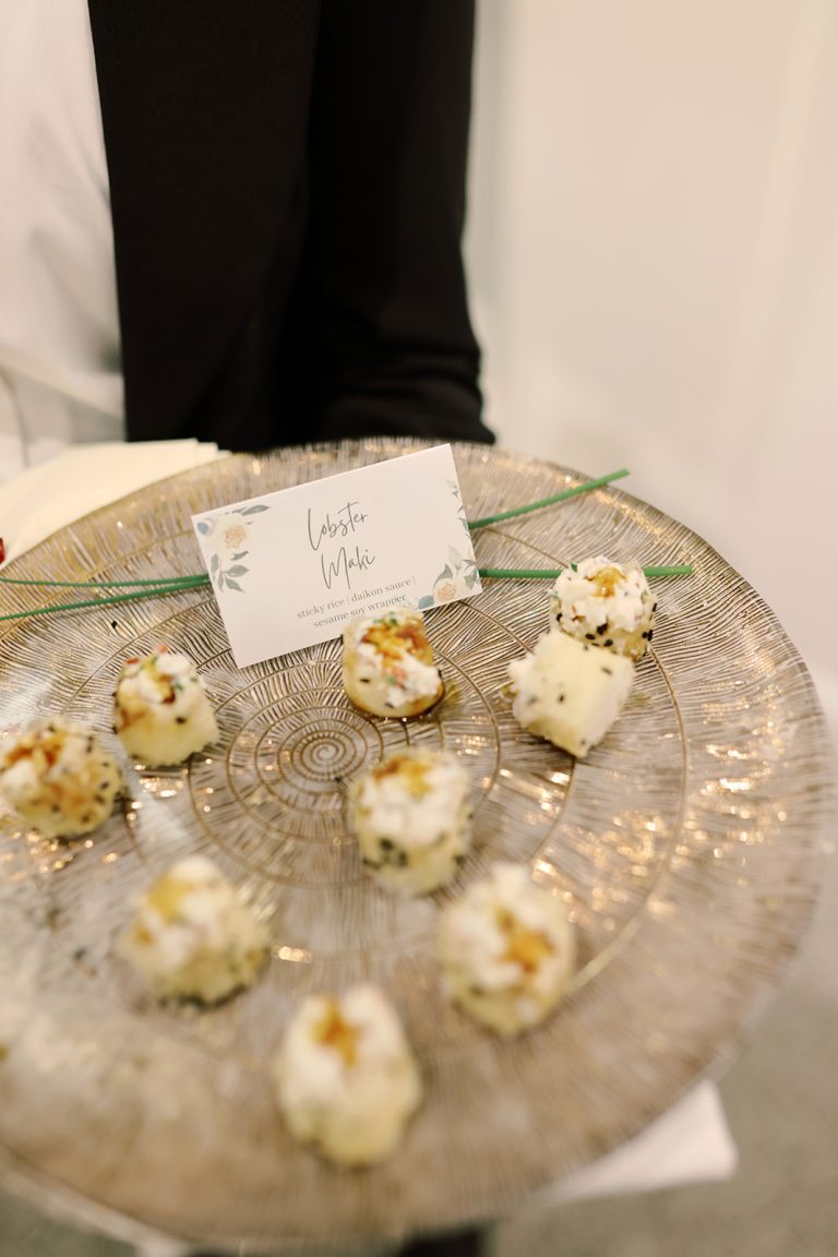 Lobster mochi bites with sticky rice and yuzu sauce on a decorative glass tray