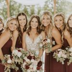 Bridal party with coordinated hair and makeup showing burgundy and ivory wedding color scheme