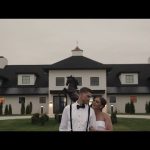 Wedding couple walking in front of upscale venue building