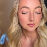 Blonde bride with romantic makeup, defined eyes, rose lip, and loose waves