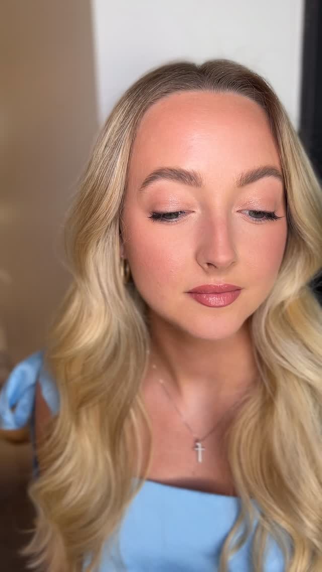 Blonde bride with romantic makeup, defined eyes, rose lip, and loose waves