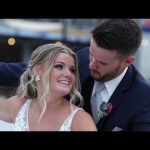 Joyful bride and groom embracing outdoors at their wedding celebration