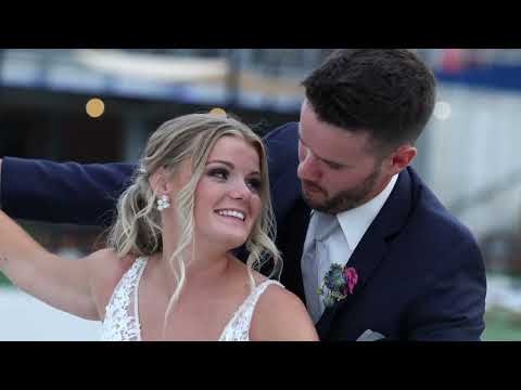 Joyful bride and groom embracing outdoors at their wedding celebration