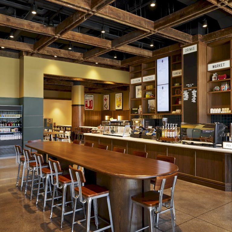 The Scarlet Hotel Nebraska cafe featuring oval communal table, espresso bar, and industrial-modern design