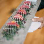 Seared tuna slices arranged on slate platter with microgreens, served at catered event