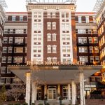 The Cottonwood Hotel at golden hour with illuminated windows and manicured front lawn