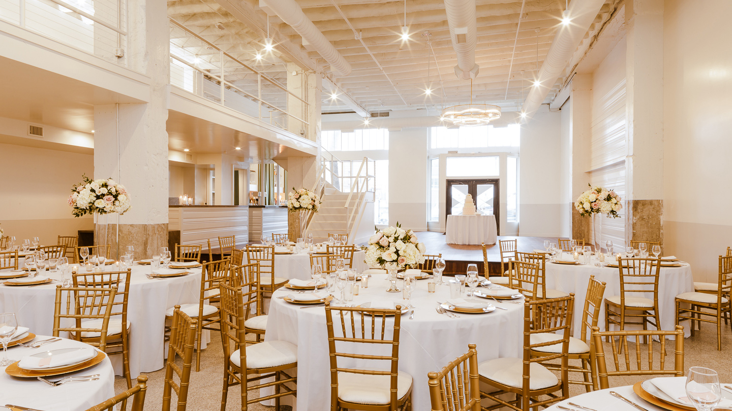 Two-story event space at Hotel Deco arranged for wedding celebration with mezzanine level and sophisticated décor