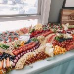 Professional grazing table spread with cured meats, artisan cheeses, fresh produce, and crackers by Grazing Gouda Nebraska
