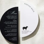 Circular black and white wedding menu and allergy card with guest name in modern typography